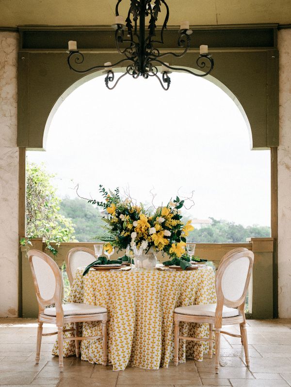 Santolina Golden linen tablecloth rental displaying sun-drenched golden embroidery and luminous neutral base fabric
