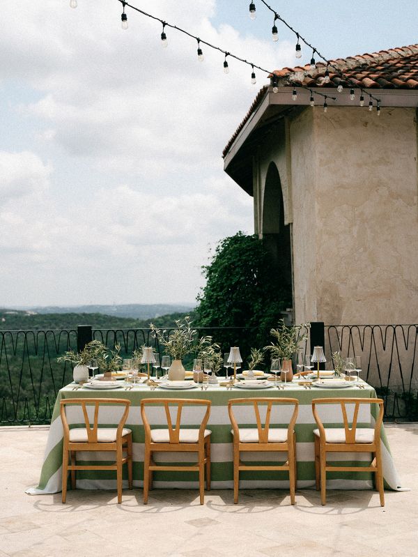 Vintage Stripe Palm tablecloth from Sorrento Sunkiss collection styled for outdoor dining with Mediterranean veranda elegance