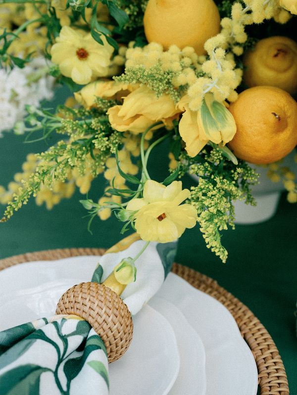 Organic-inspired table setting with green linen and sunlit florals