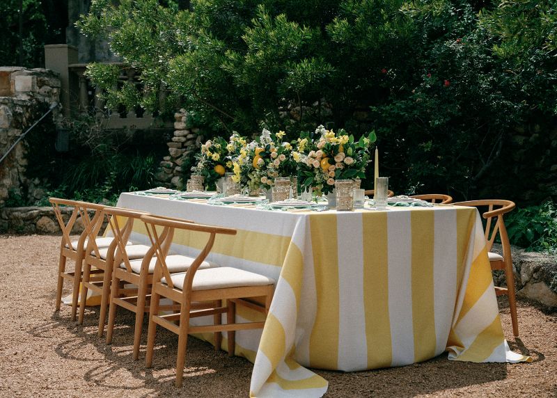 Vintage Stripe Zest linen tablecloth rental displaying radiant citrus hues perfect for sun-kissed gatherings and lingering meal