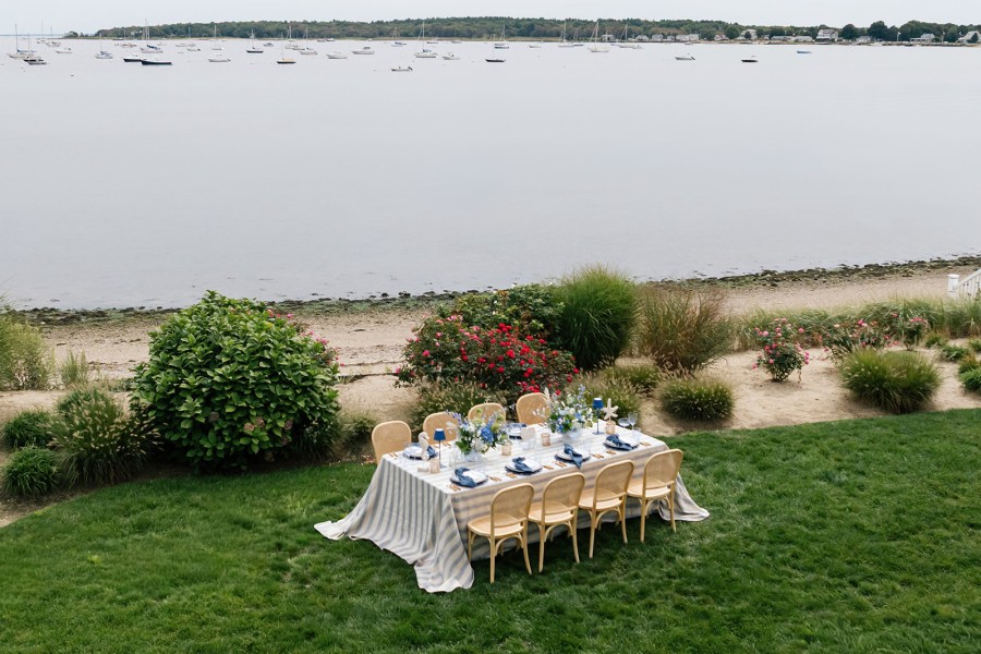 Elegant seaside dinner setup with blue linen