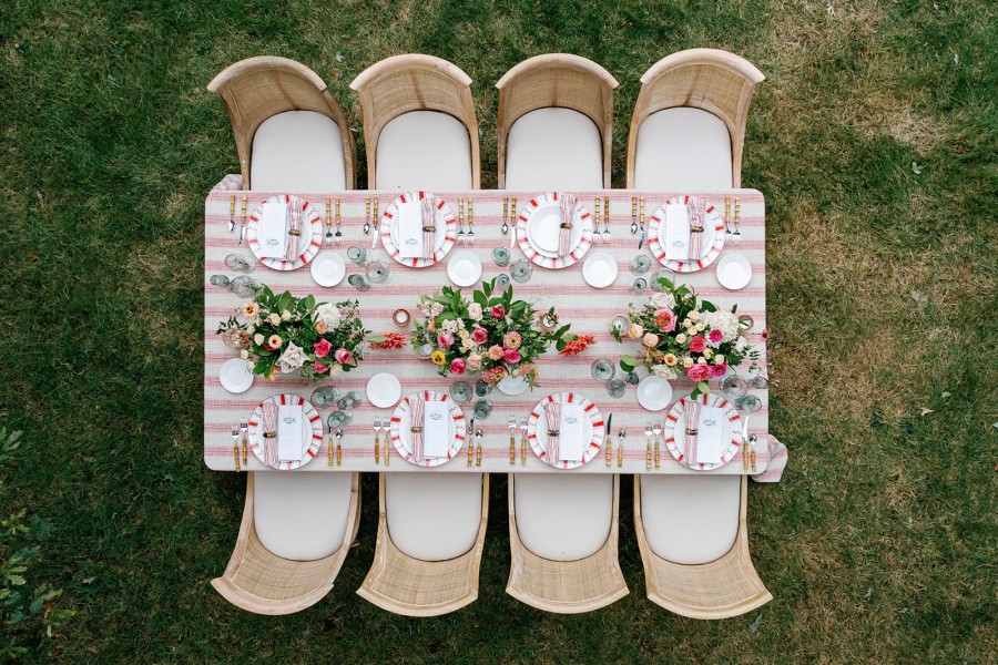 Elegant dinner setup with crimson coastal fabric