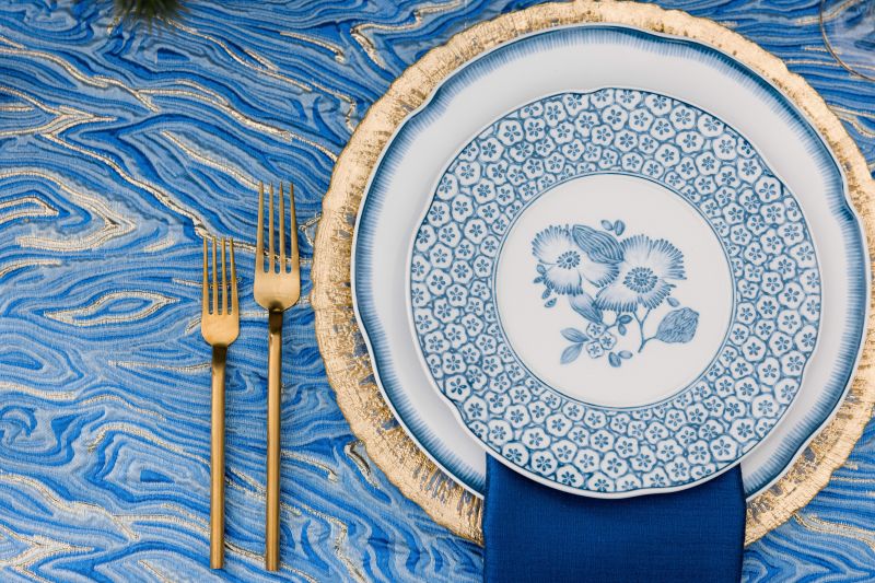 Close-up of Elara Lapis fabric’s gold-thread texture