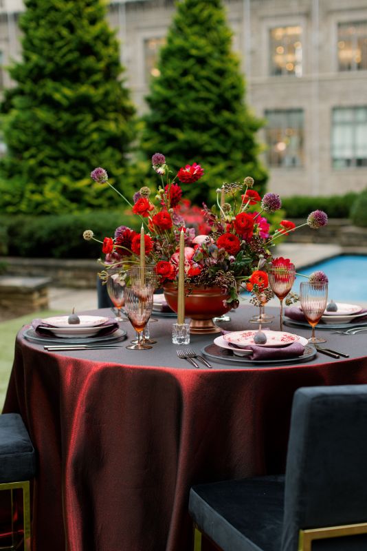 Jewel-tone wedding décor with metallic red linen